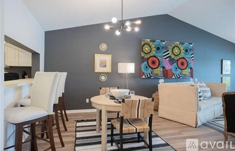 A living room with a dining table and chairs.