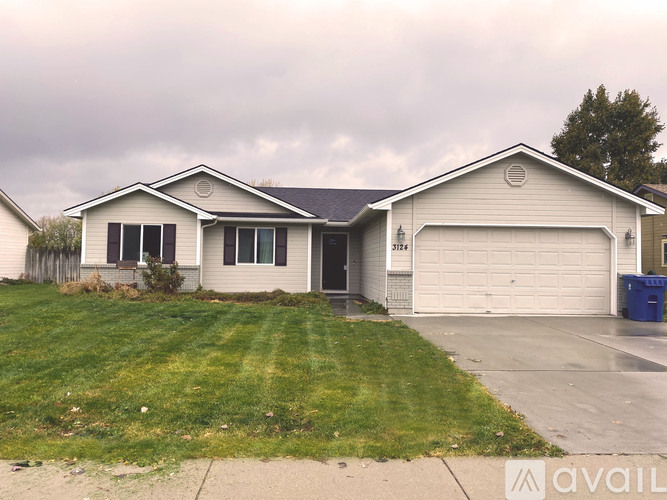 A house with a garage and a driveway in front.
