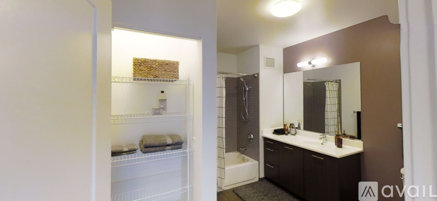 A bathroom with a white cabinet and a brown counter.