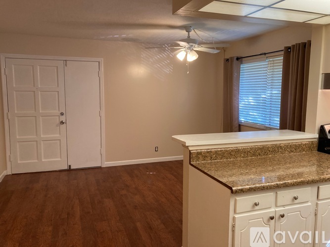 A kitchen with white cabinets and a countertop.
