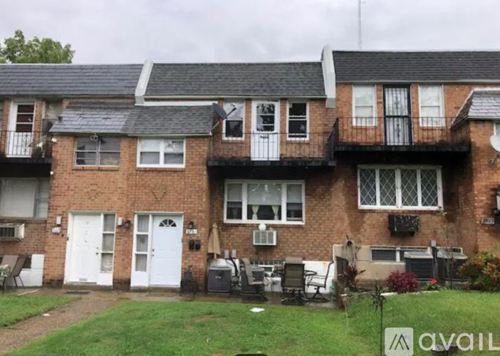 A row of houses with balconies and a sign in front.