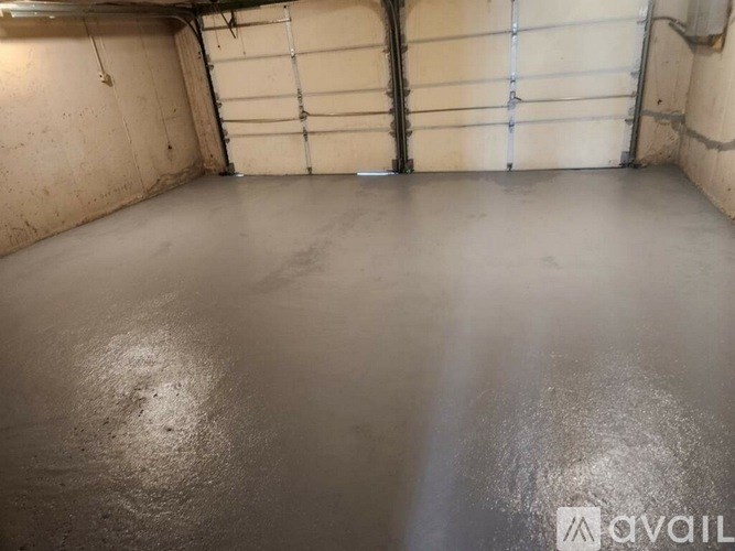 A spray-painted garage floor with a white line down the middle.