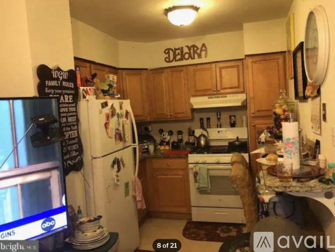 A kitchen with wooden cabinets and a white fridge.