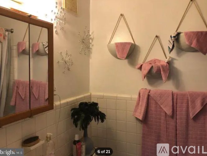A bathroom with a pink towel hanging on a towel rack.
