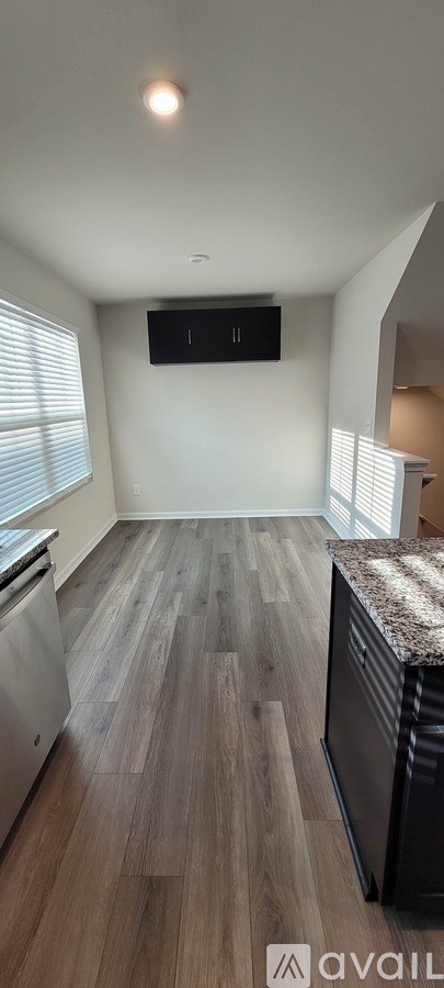 A kitchen with wooden floors and a countertop.