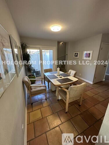A dining room with a table and chairs is shown in the image.