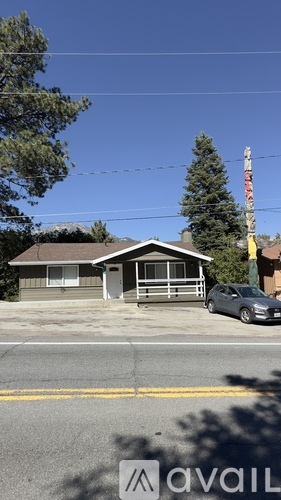 A house with a grey roof and a grey car parked in front.