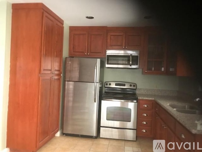 A kitchen with wooden cabinets and stainless steel appliances.