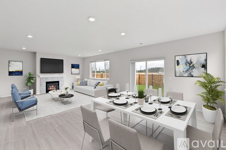 A modern living room with a fireplace and a dining table set for six.