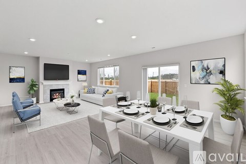 A modern living room with a fireplace and a dining table set for six.