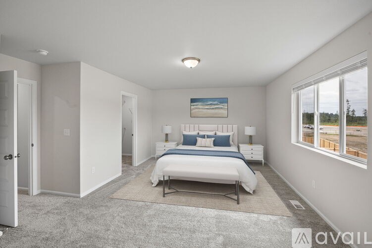 A bedroom with a large bed and a painting on the wall.