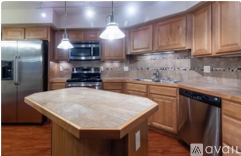 A kitchen with wooden cabinets and a central island.