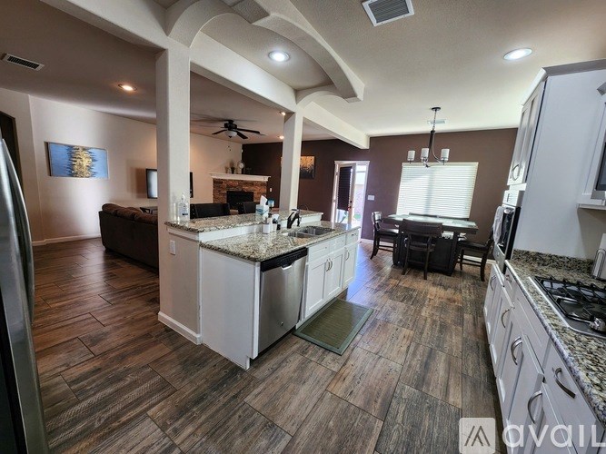A kitchen with a large island and a dining area.