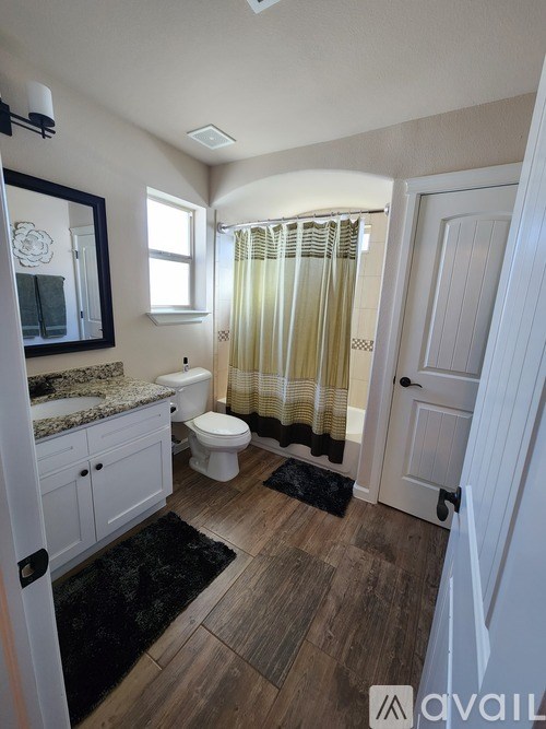 A bathroom with a toilet, sink, and shower.