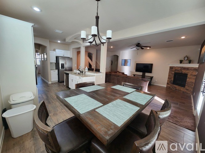 A modern dining room with a large table and chairs.