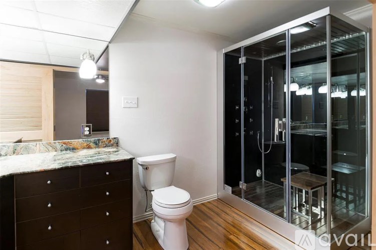 A bathroom with a toilet, sink, and shower.