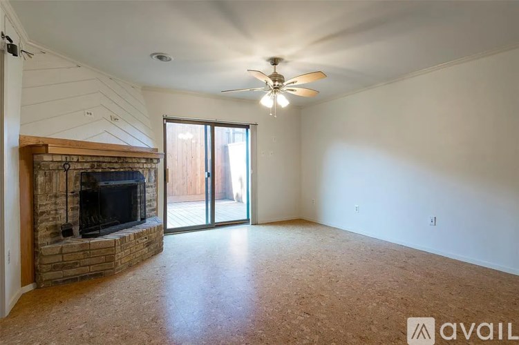 A living room with a fireplace and sliding glass doors.