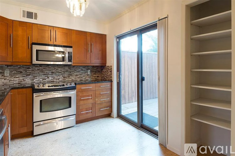A kitchen with a stove top oven and microwave above it.
