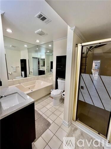 A bathroom with a sink, toilet, and bathtub.
