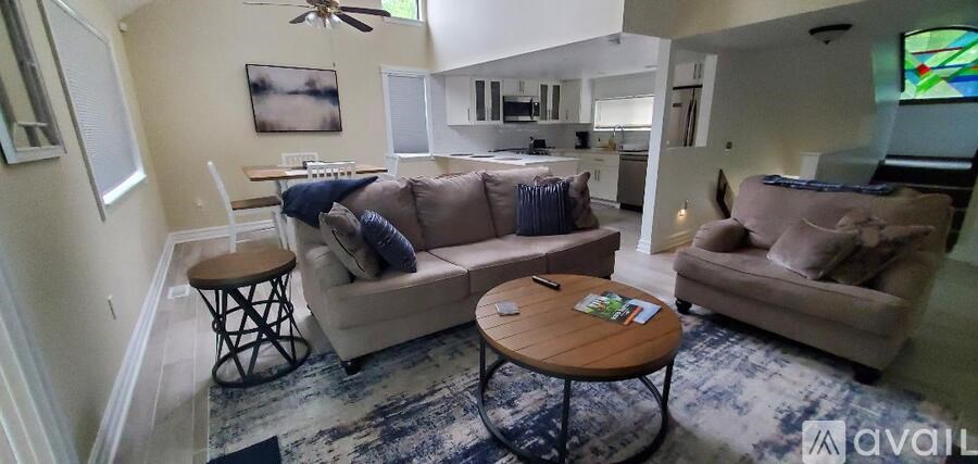 A living room with a couch, a chair, and a coffee table.