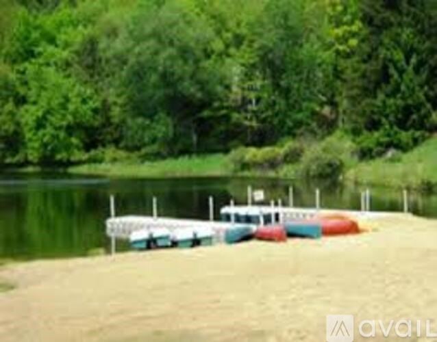 A row of boats are lined up on a sandy beach.