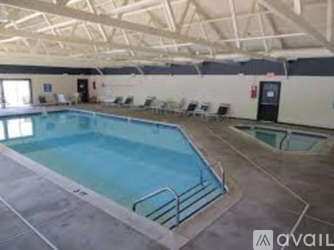 A large indoor swimming pool with a glass barrier.