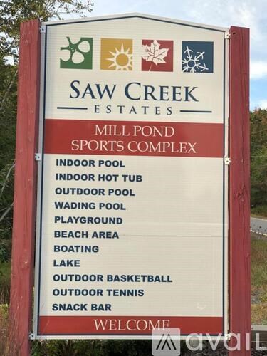 A sign for Saw Creek Estates Mill Pond Sports Complex lists the amenities available.