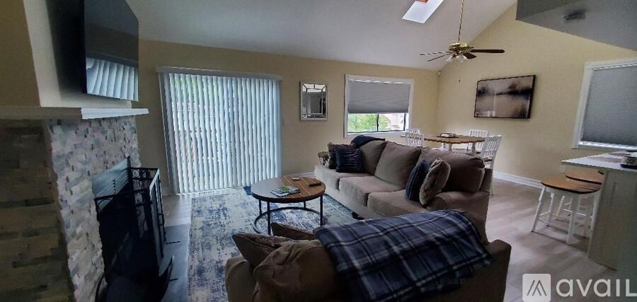 A living room with a couch, a coffee table, and a television.