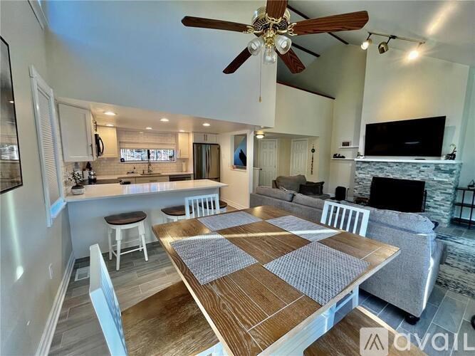 A modern dining room with a wooden table and chairs.