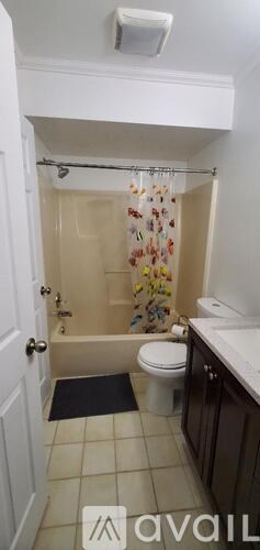 A bathroom with a toilet, sink, and shower.