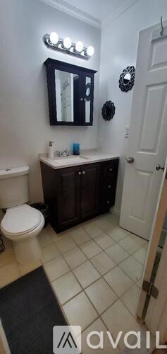 A bathroom with a white toilet and a white sink.