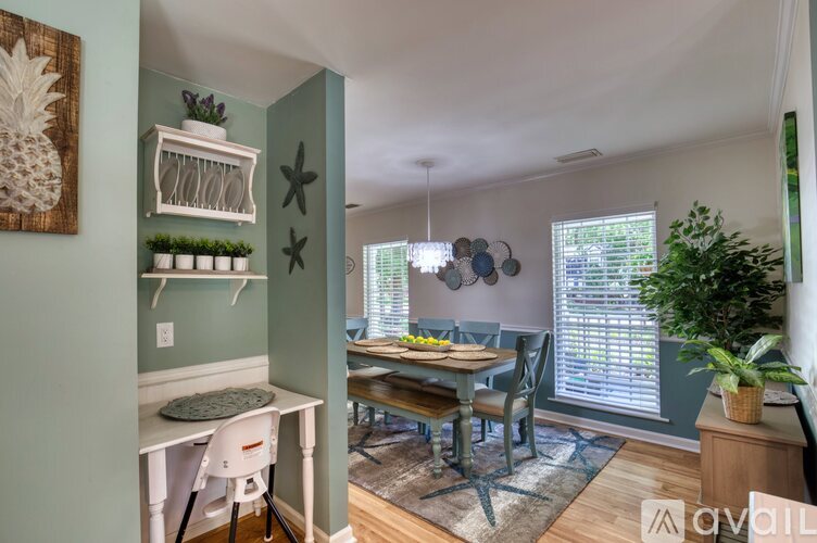 A dining room with a table and chairs.