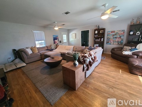 A living room with a brown sofa and a wooden coffee table.