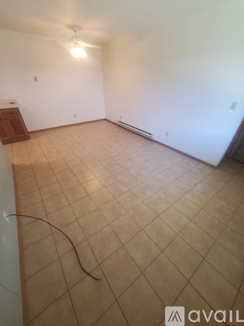 A room with a tiled floor and a ceiling fan.