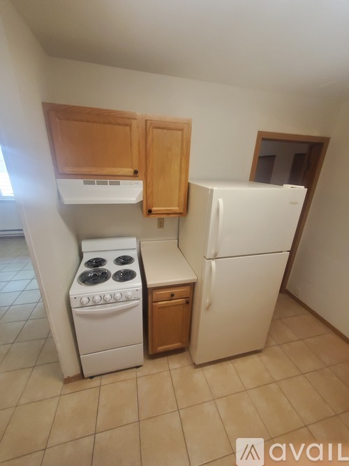 A kitchen with a white fridge, stove and oven.