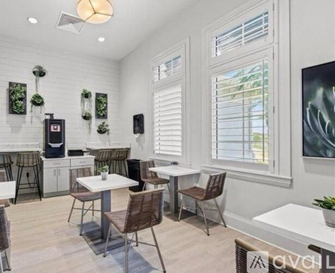A white dining room with a table and chairs.