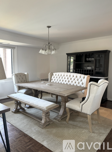 A dining room with a wooden table and chairs.