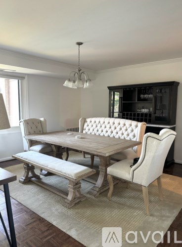 A dining room with a wooden table and chairs.