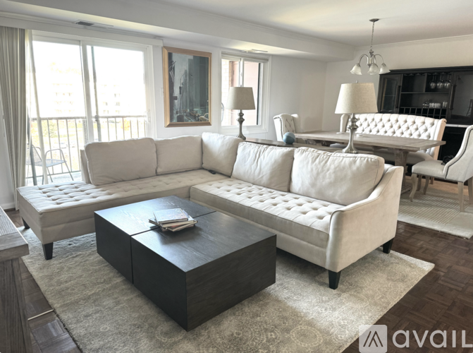 A living room with a white sofa and a coffee table.