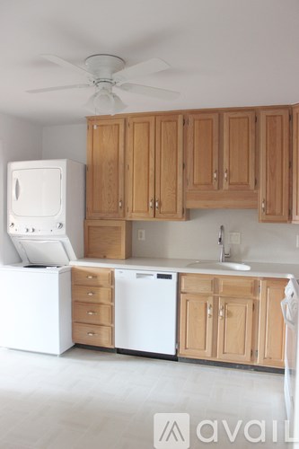 A kitchen with wooden cabinets and white appliances.