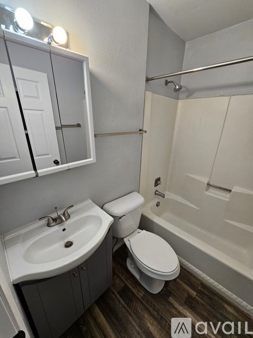 A bathroom with a toilet, sink, and bathtub.
