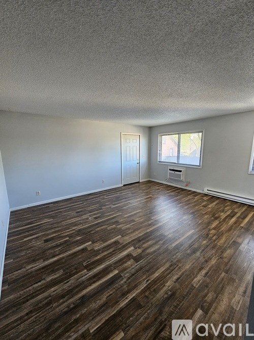 A kitchen area with black appliances and a tiled floor.