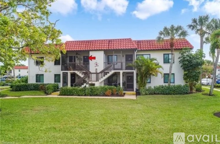 A house with a red roof and a balcony is for sale.