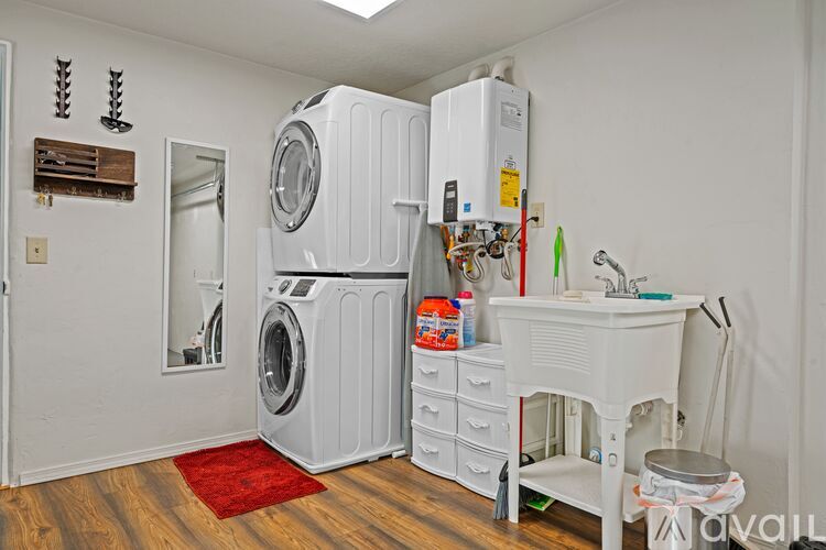A laundry room with a washer and dryer stacked on top of each other.