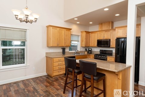 A kitchen with wooden cabinets and a granite countertop.