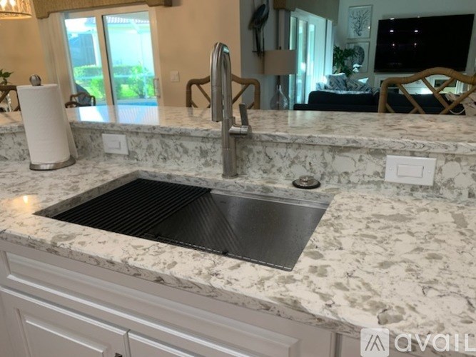 A kitchen counter with a sink and a faucet.