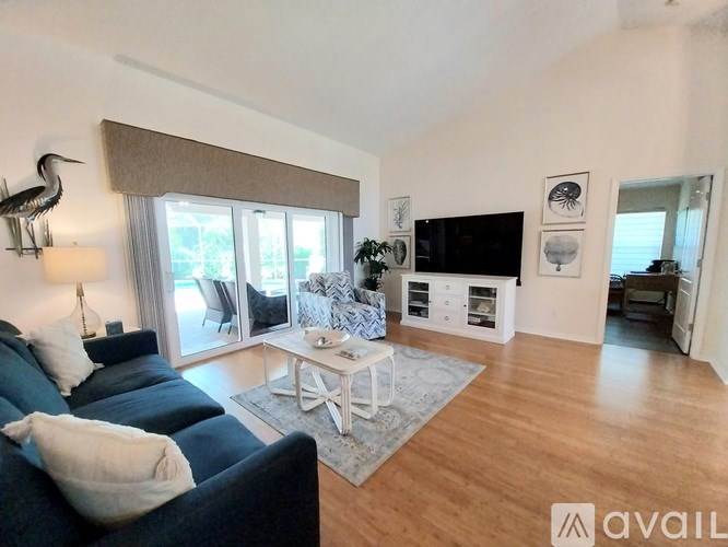 A living room with a dark blue sofa and a white coffee table.
