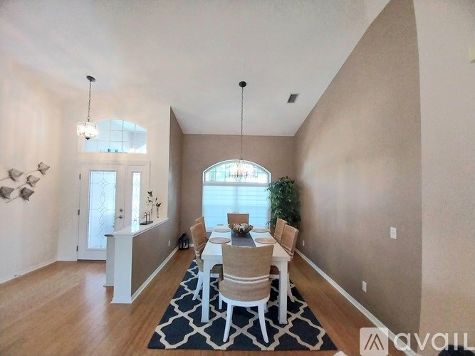 A dining room with a table set for four.