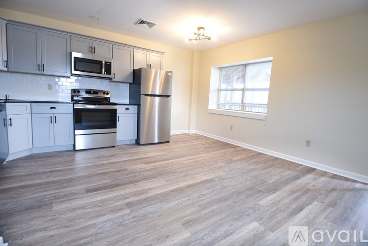 A kitchen with a stainless steel refrigerator and stove.