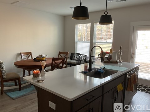 A kitchen with a table and chairs is available for rent.